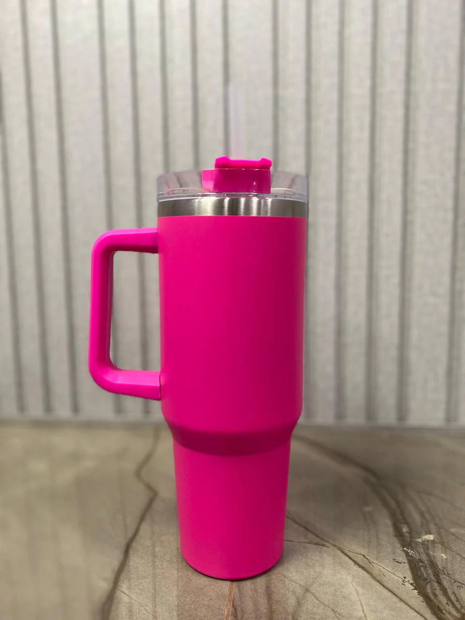 Stainless steel insulated tumbler placed in car cup holder.