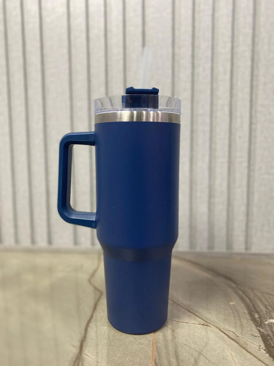 Stainless steel tumbler with leak-proof lid and reusable straw.